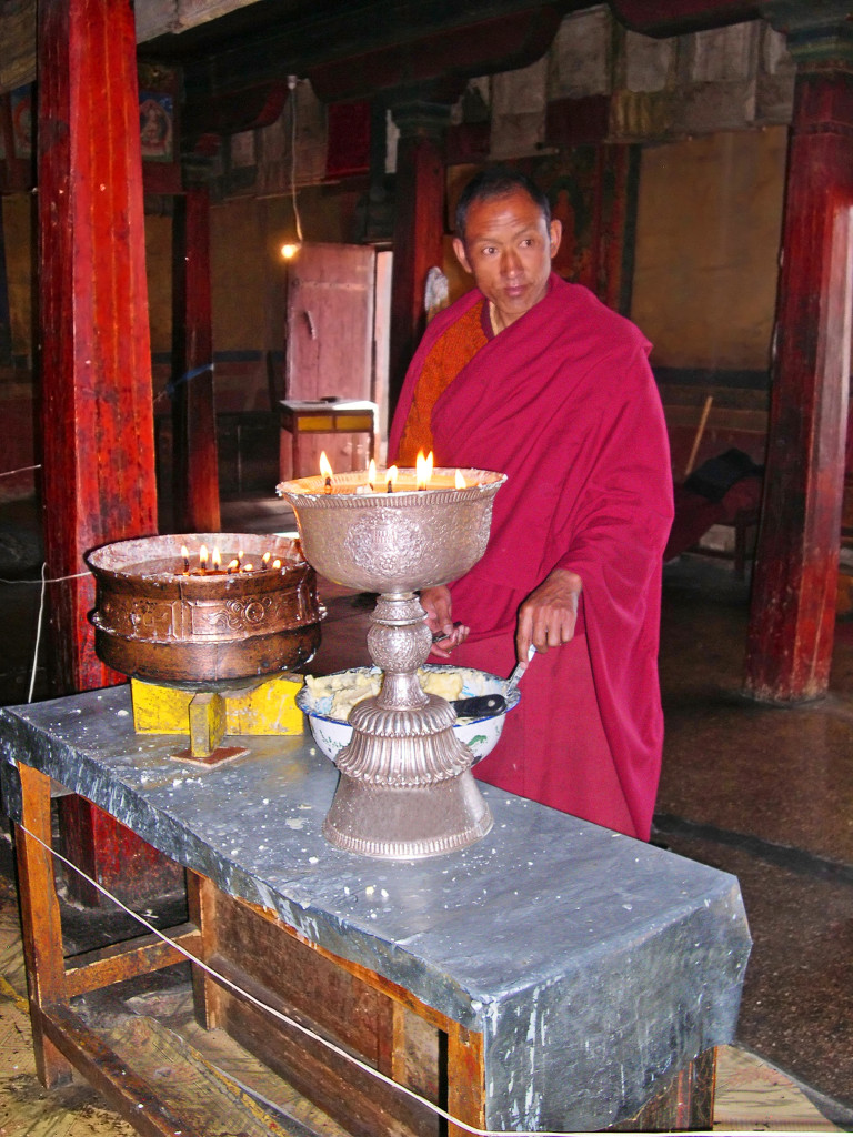 shutterstock_136676471 buddhist monk in temple tibet