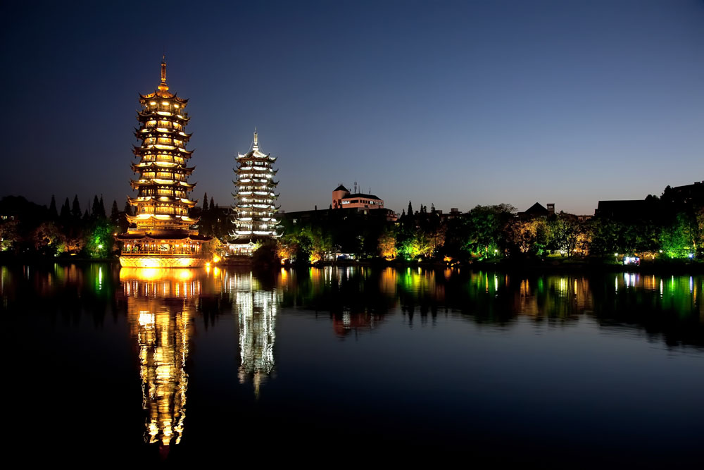 shutterstock_122283634 Guangxi, Evening view of the Gold and Silver Pagodas, also known as the Sun and Moon Pagodas, reflected in Shan Lake Guilin, Guangxi, China