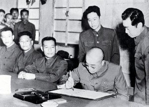 General Peng Dehuai signs armistice ending the Korean War